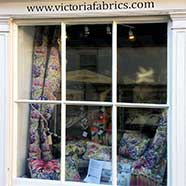 A display of Voyage fabrics and cushion covers in the window of our new workshop.